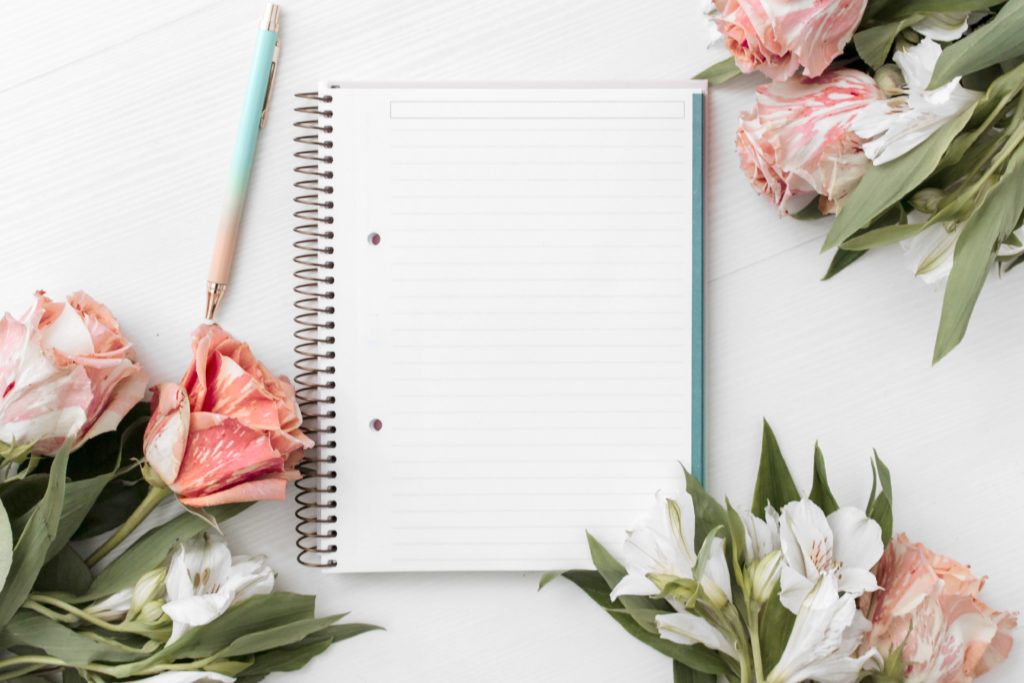 Header with notebook, pencil and flowers